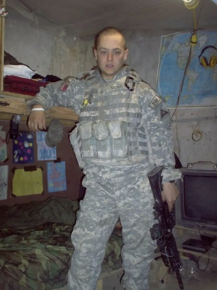 Chris Spositi in ACU uniform with name tape SPOSITI, deployed in a forward operating base bunker